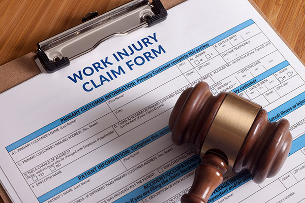A brown gavel resting on top of a claim form used by Oakland work injury lawyer.